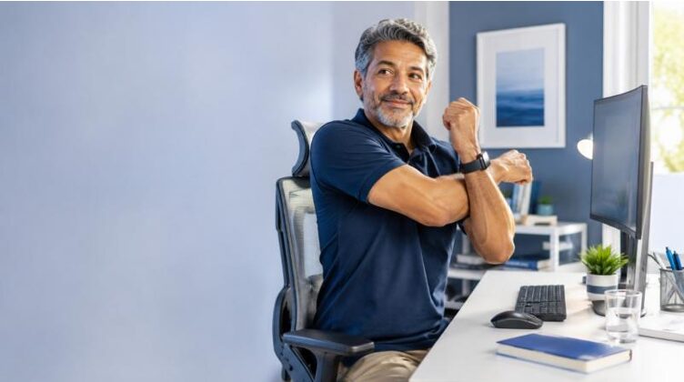 Man does stretching exercises at the office to prevent pain caused by poor posture at work